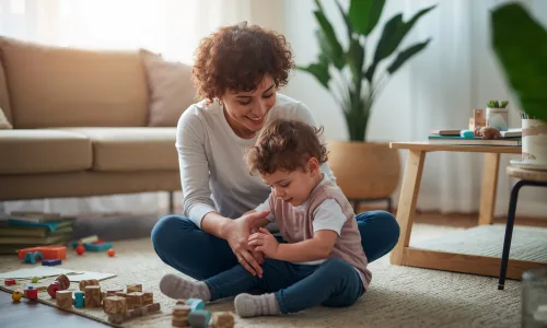 child playing with an adult beside her