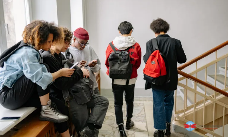 Teenagers, some sitting in the hallway