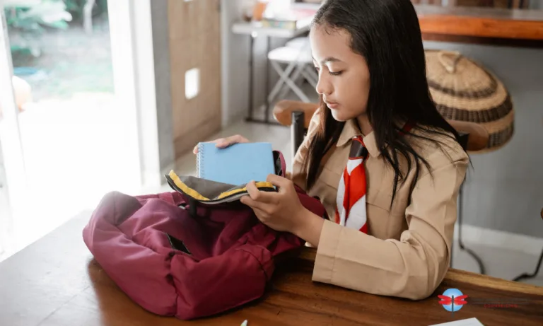 teenager putting notebook on her bag