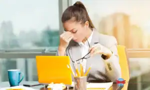 The woman looks overworked on her office